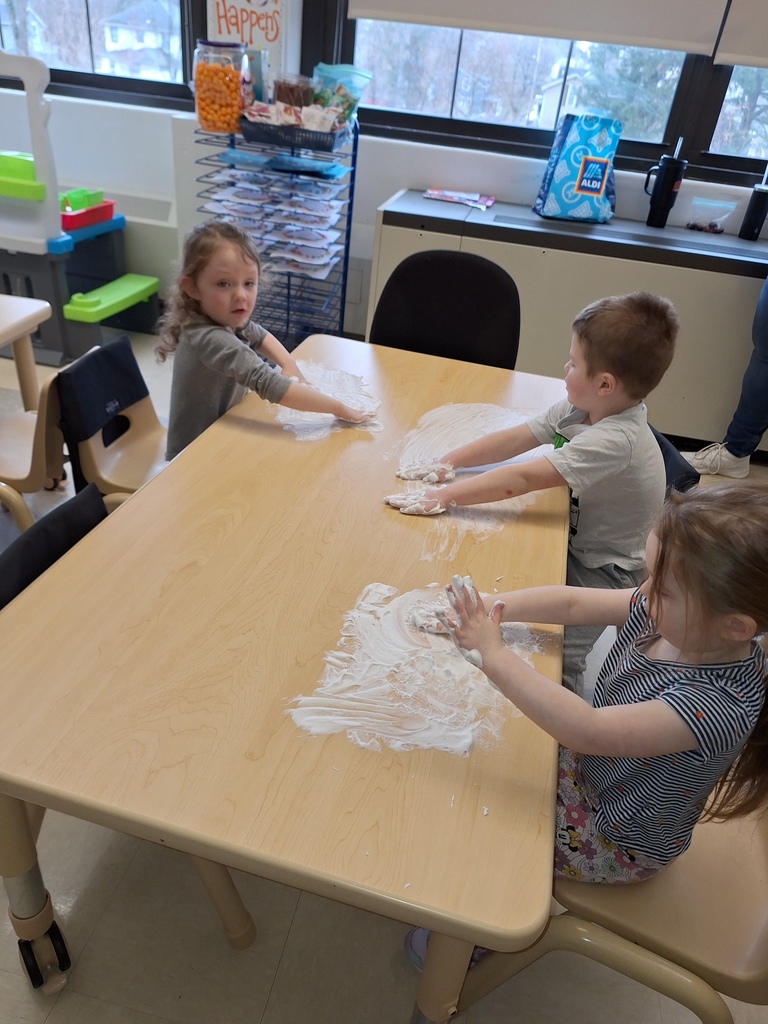 students playing with shaving cream on table