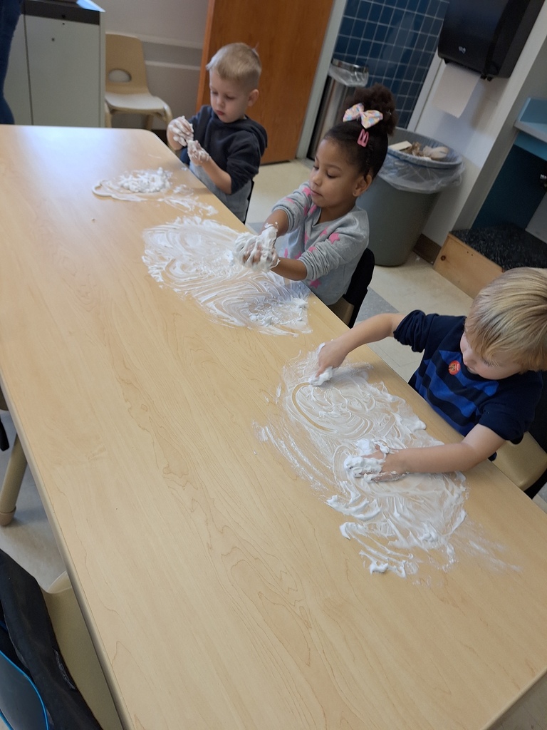 students playing with shaving cream on table