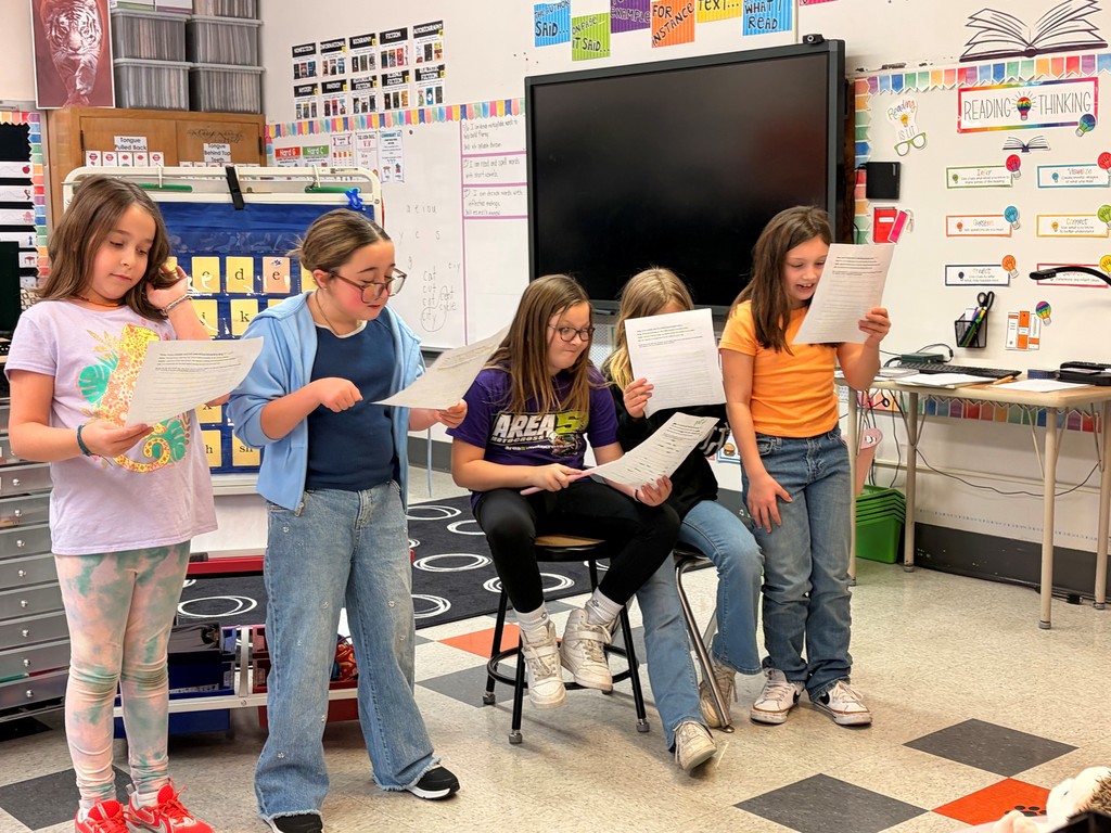 students reading from worksheets in classroom