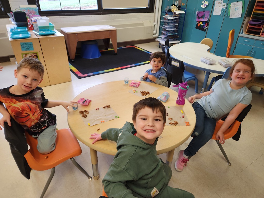 students sitting at table eating snacks