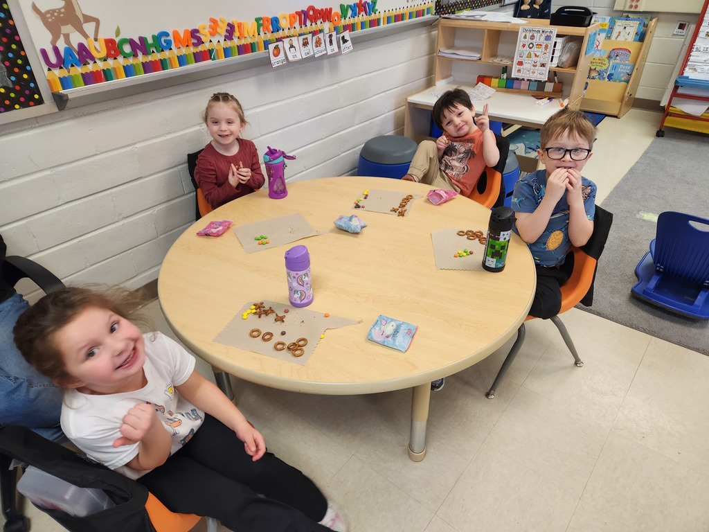 students sitting at table eating snacks