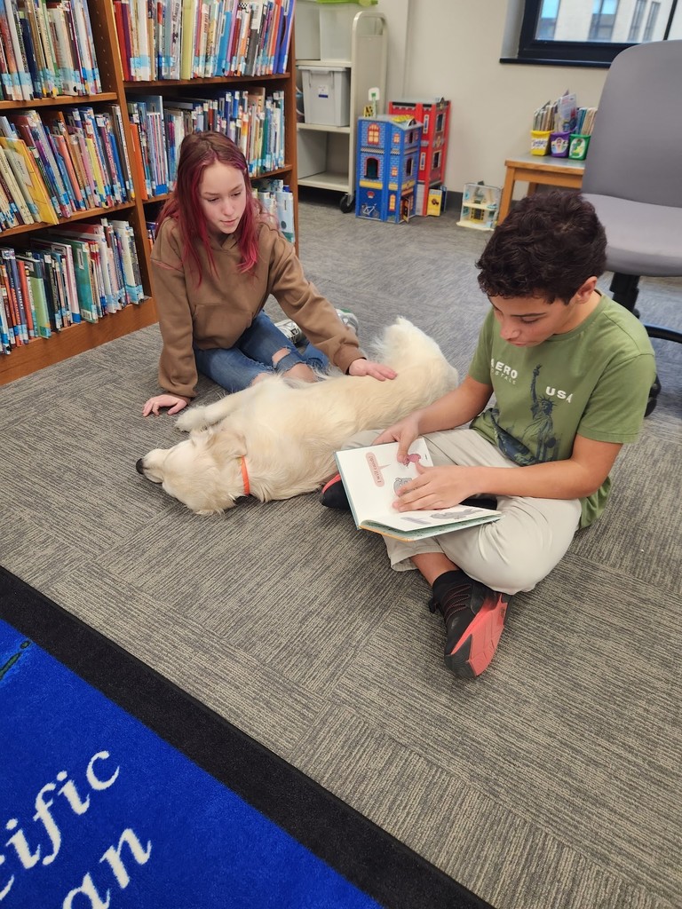 two students in library with dog