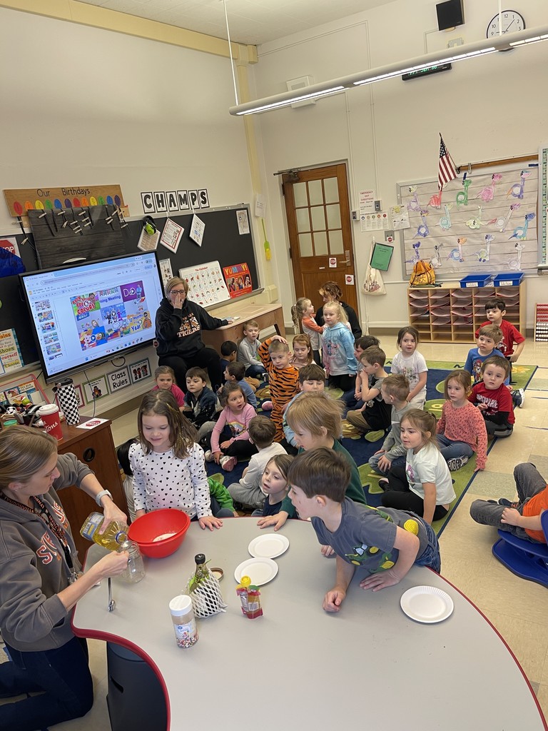 students in classroom listening to teachers