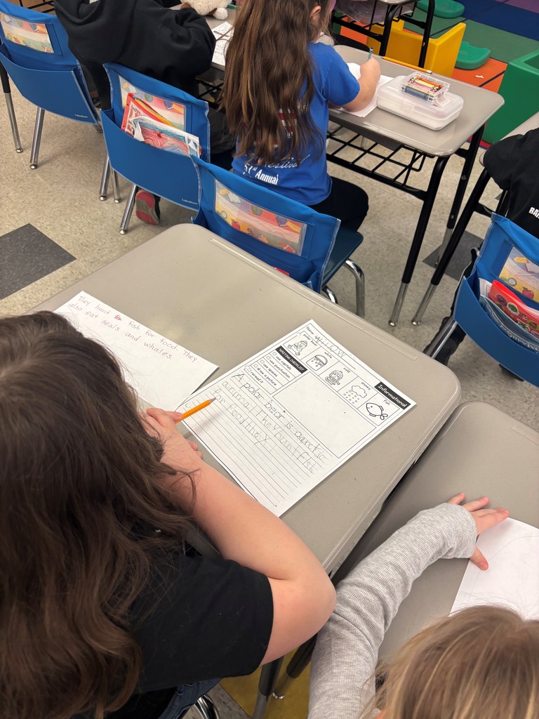 stiudents sitting at desks with worksheets