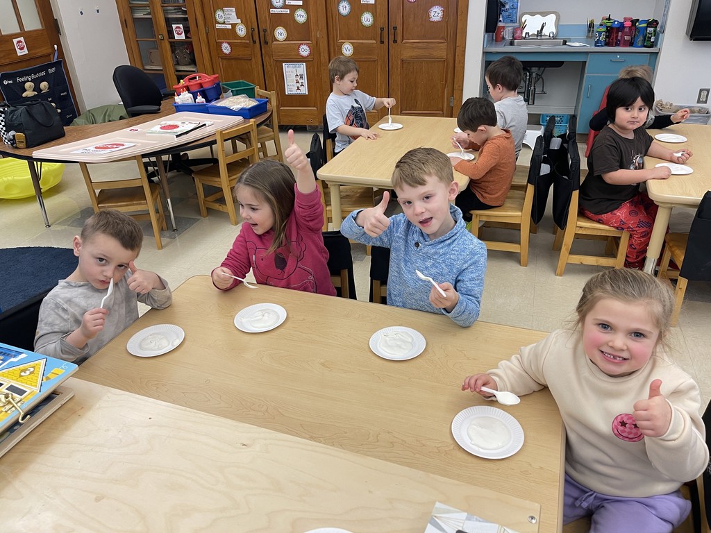 students eating ice cream and giving thumbs up