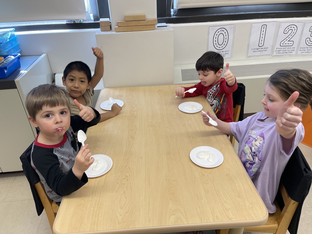 students eating ice cream and giving thumbs up