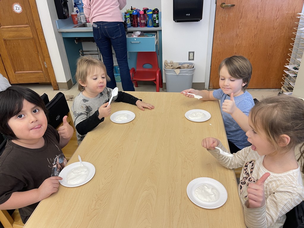 students eating ice cream and giving thumbs up