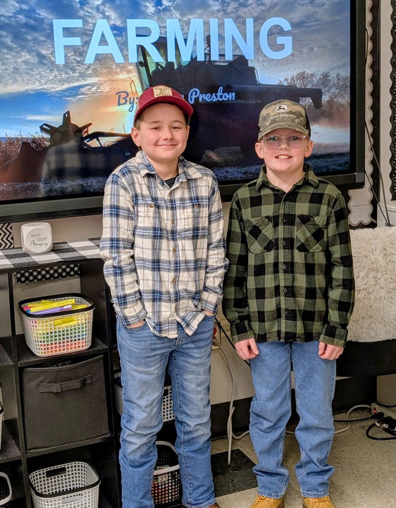 two boys in front of smart screen