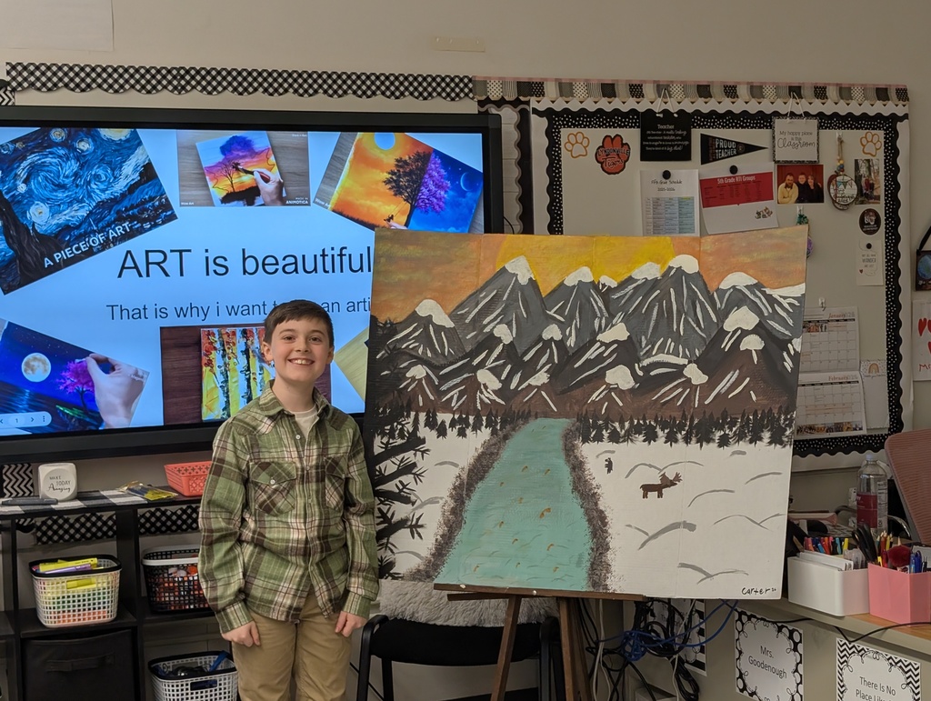 boy in front of easel with painting on it