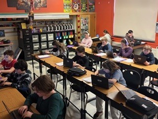 students working on computers at their desks
