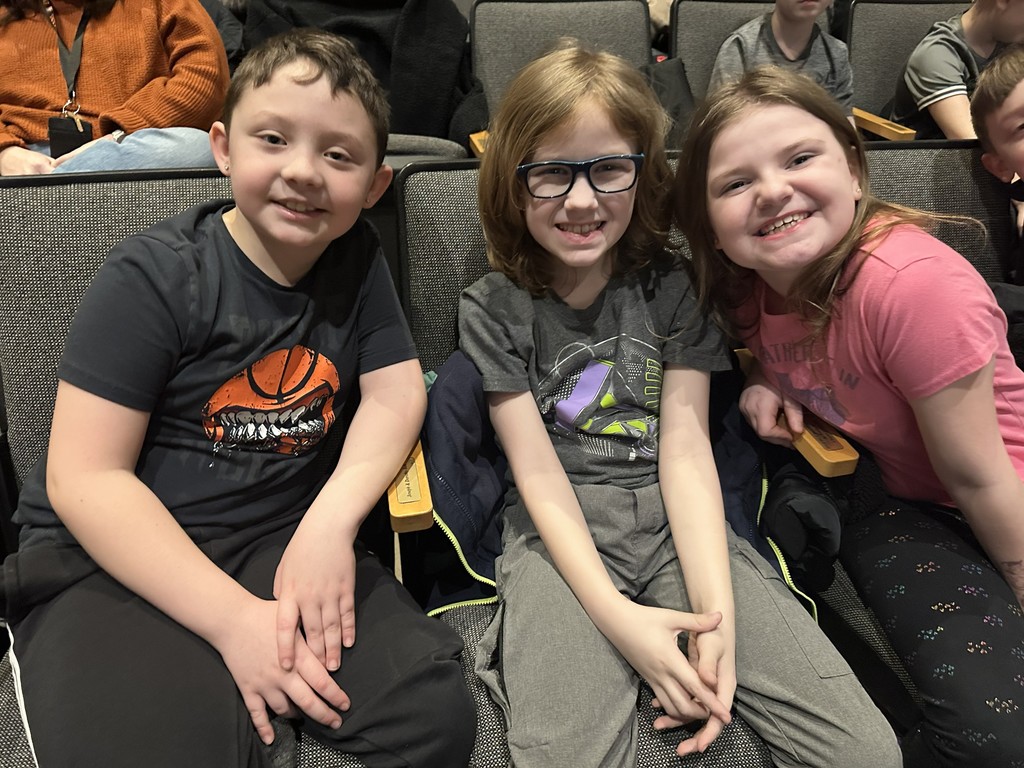 students sitting in seats in auditorium
