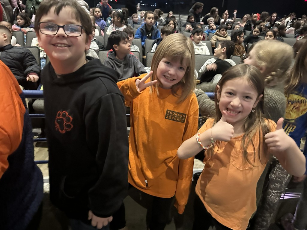 students walking to seats in auditorium