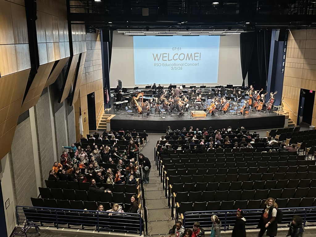 concert hall with musicians on stage and audience in seats