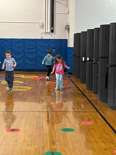 students walking through hoops on the floor