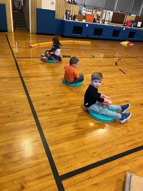 students sitting on sit and spins