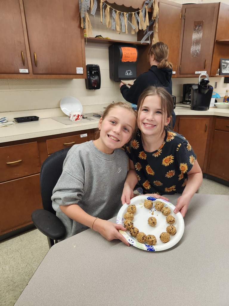 two students holding a plate of food