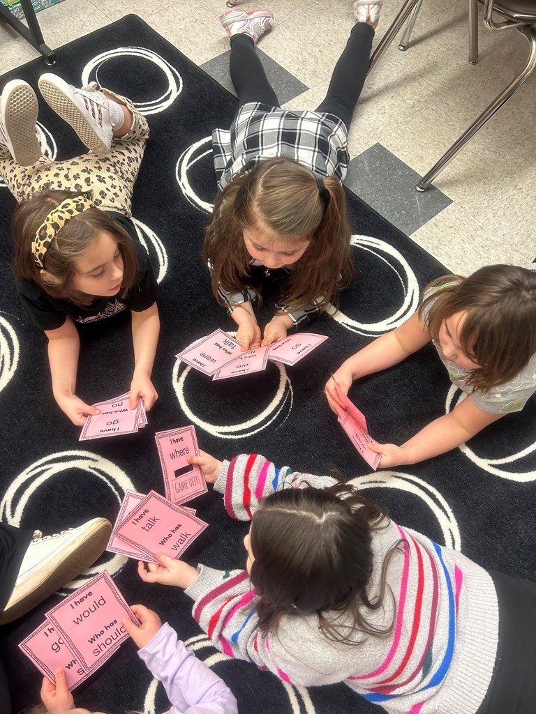 students lying on the rug playing a game