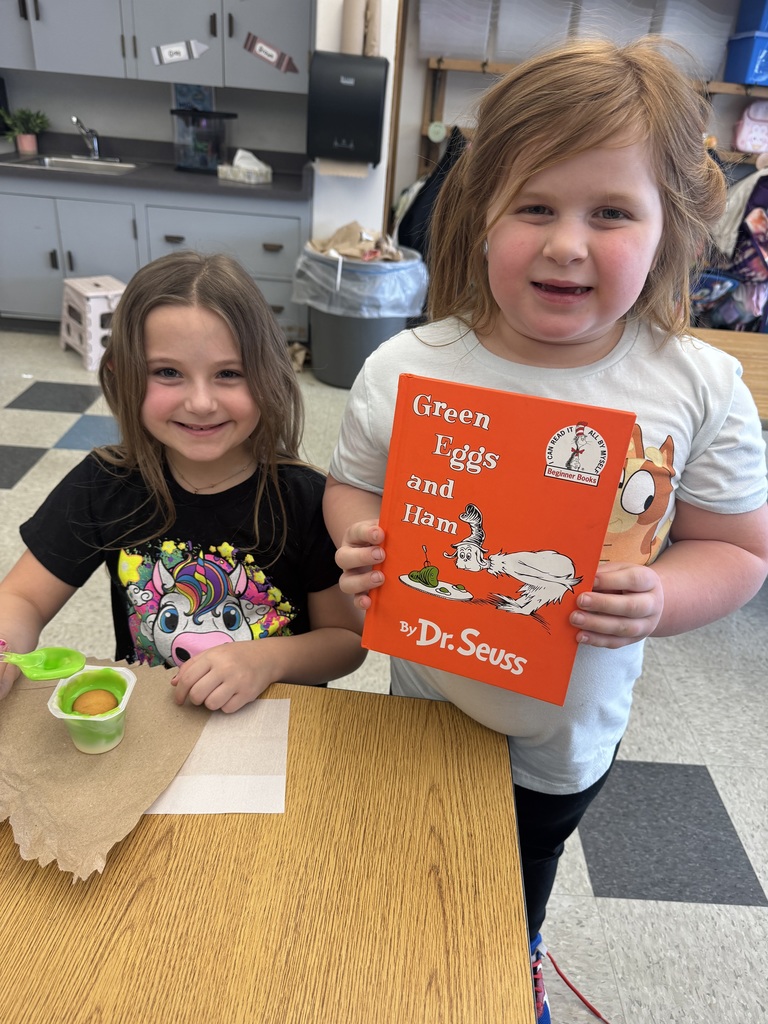 two students with book and snack