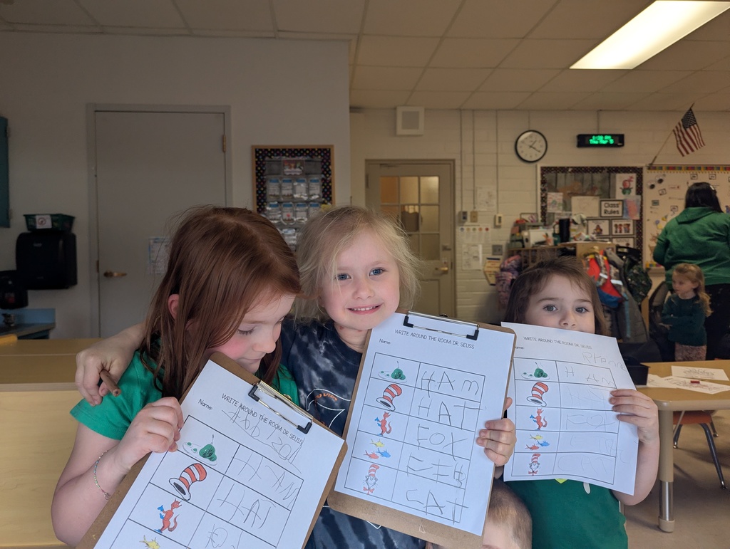 three girls holding worksheets