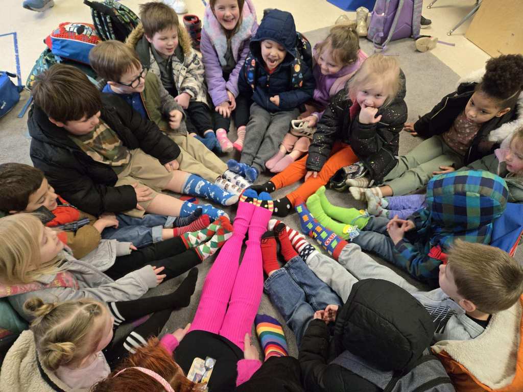 students sitting in a circle showing off their socks