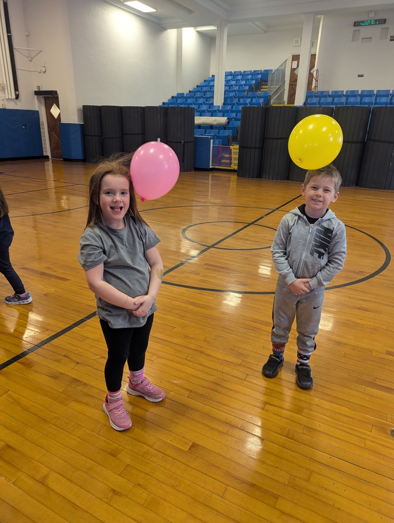students with balloons attached to their heads