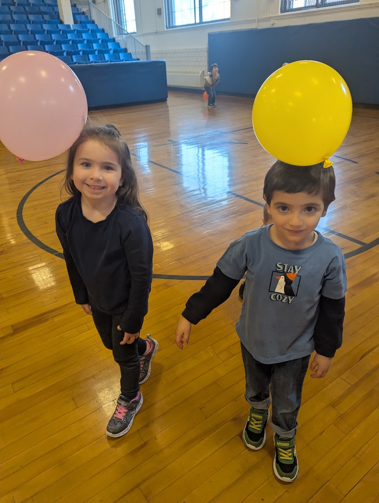 students with balloons attached to their heads