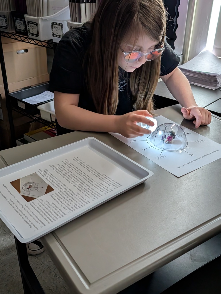 student examing something with a light