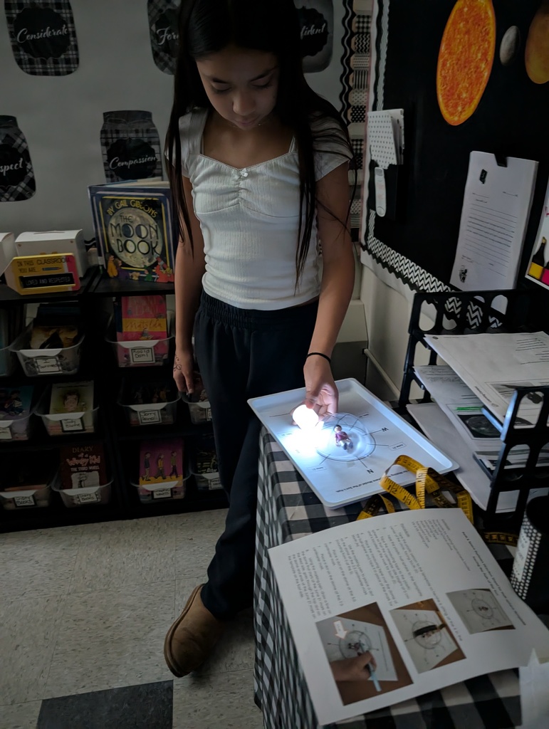 a student examingin something with a light