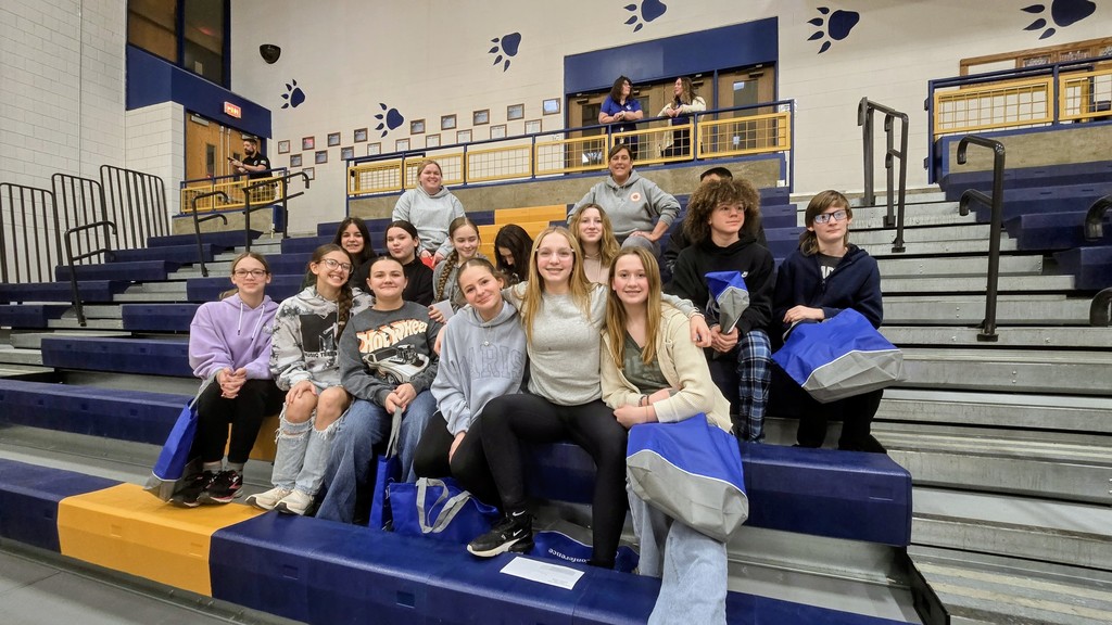 student sitting on bleachers