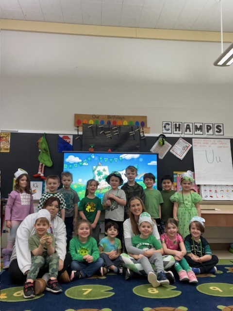 students and teacher wearing green in classroom
