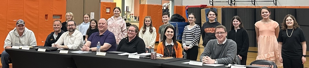 elementary all-county chorus members standing behind board of educaition members seated at table with school superintendent