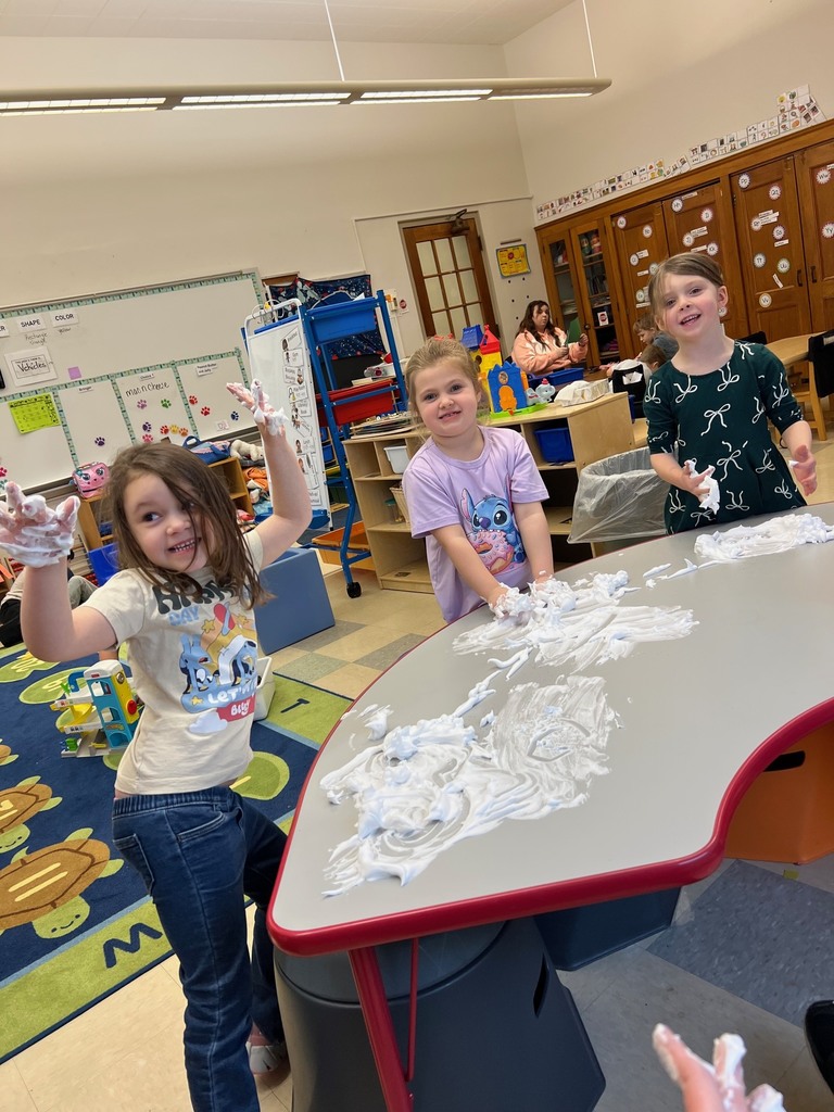 students playing with shaving cream on table