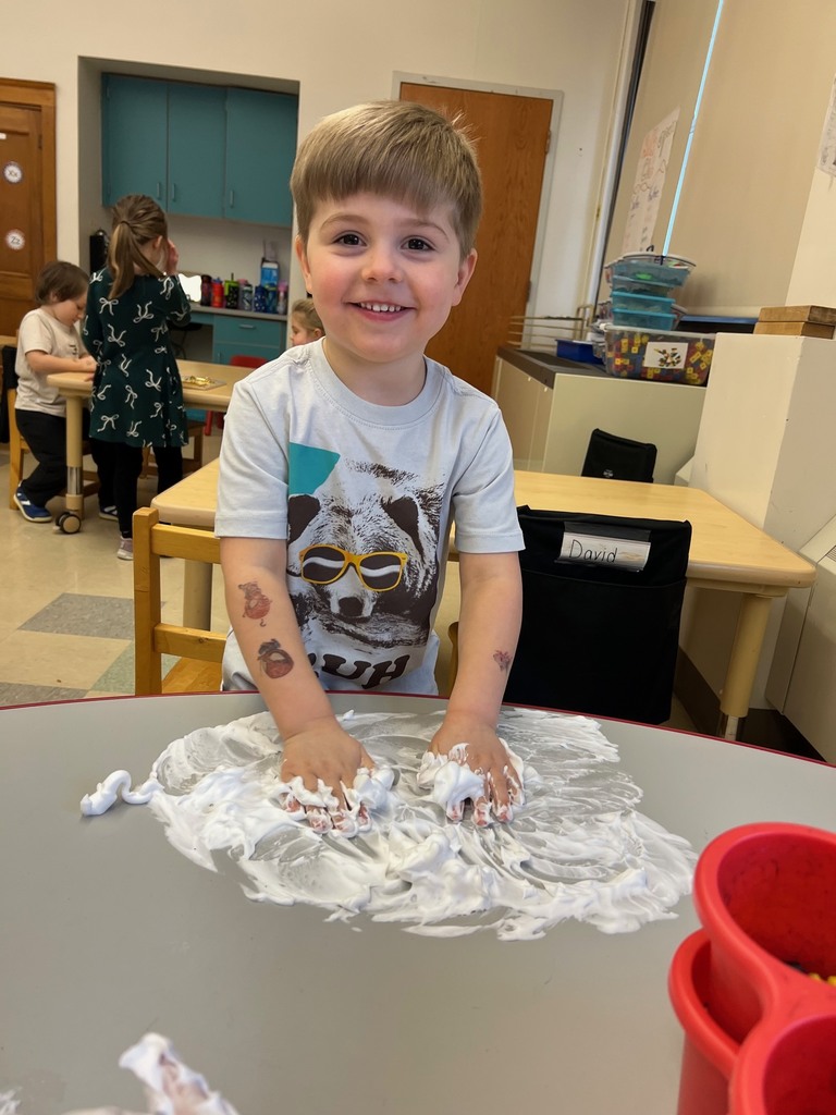 boy playing with shaving cream on table