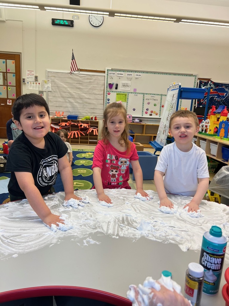 students playing with shaving cream on table