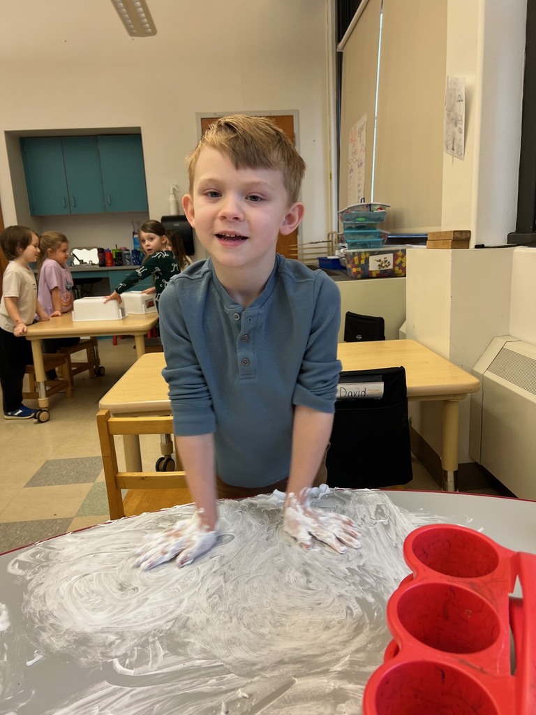 boy playing with shaving cream on table