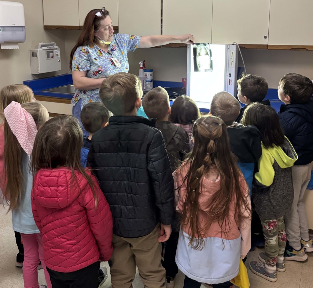 students looking at x-ray with nurse