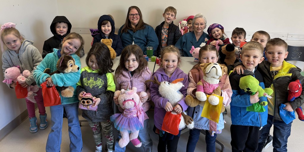 students and adult with their stuffed animals