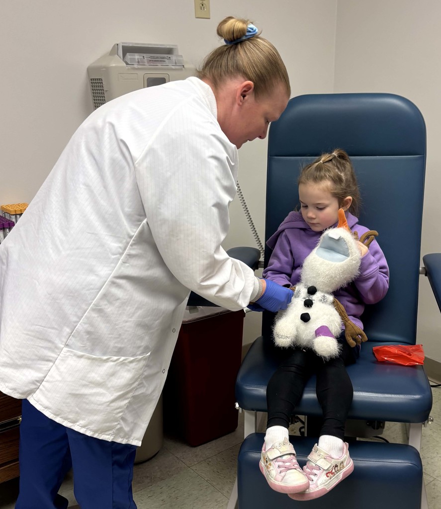 doctor assessing girl's stuffed animal