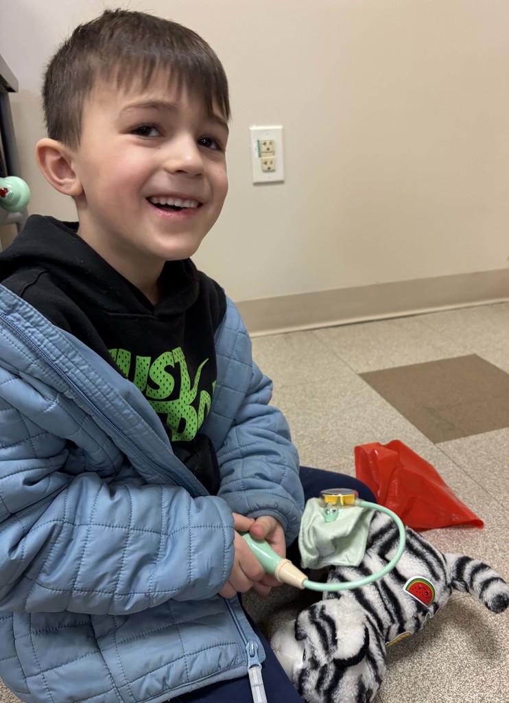 student taking stuffed animal's blood pressure