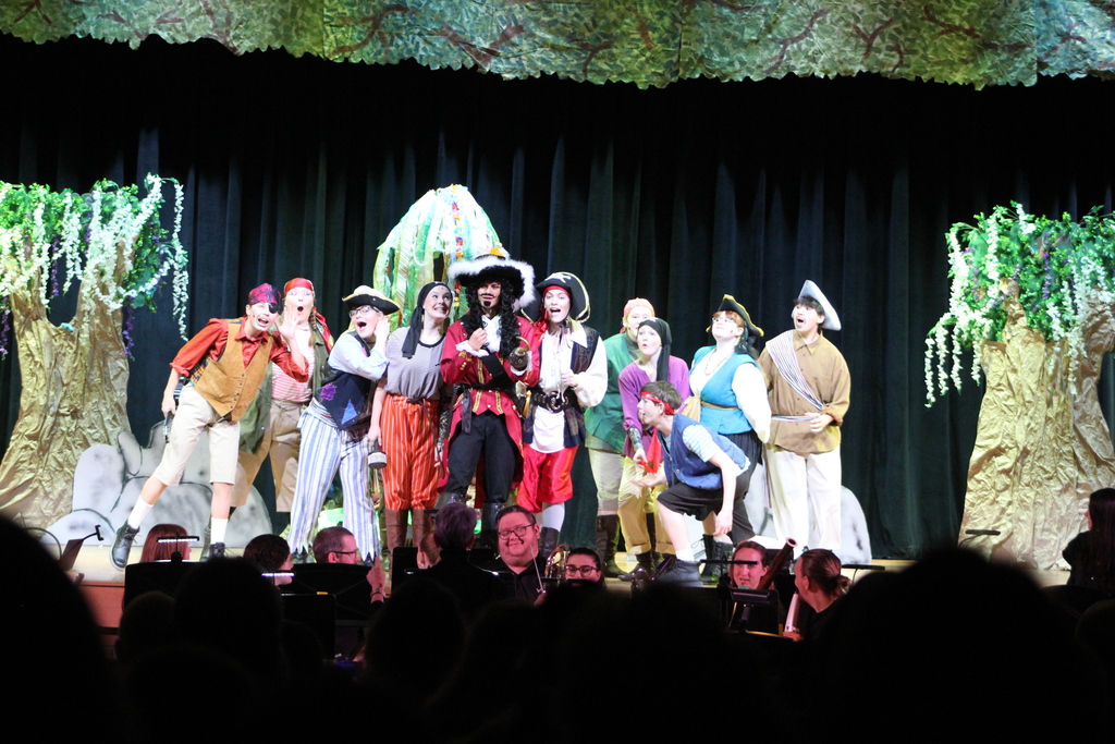 students in costume on stage
