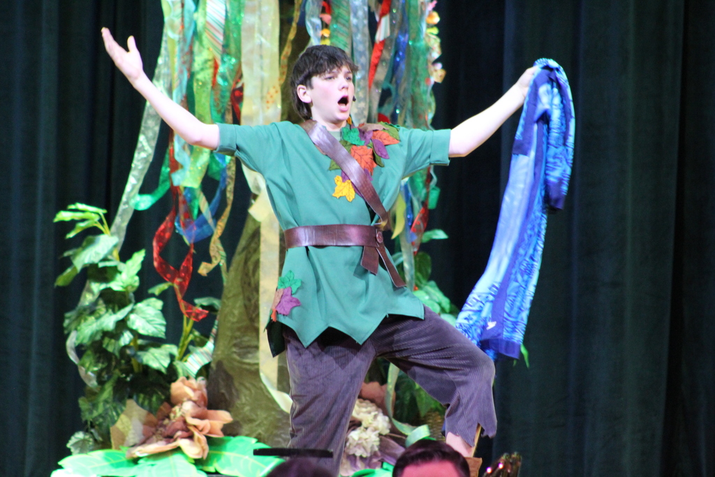 student in costume on stage