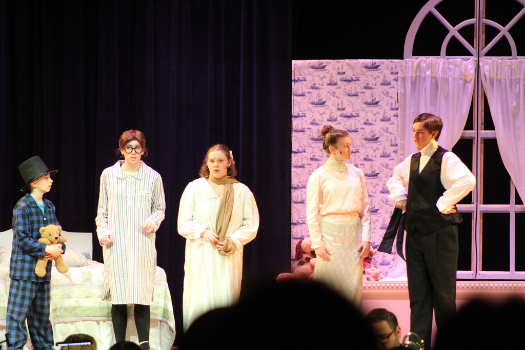 five students acting on stage