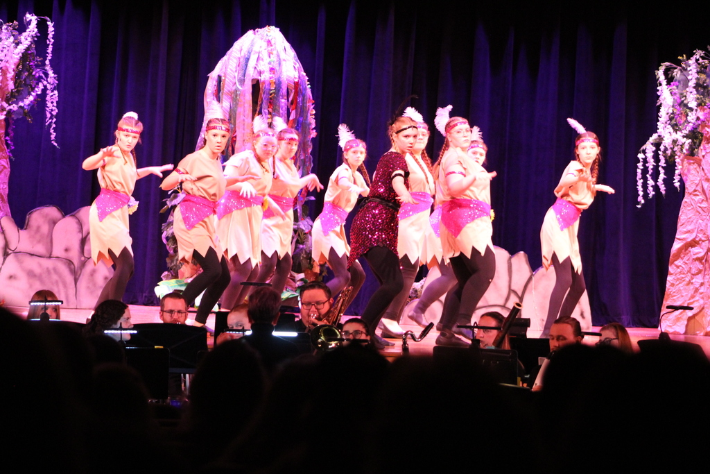 girls dancing on stage in costumes