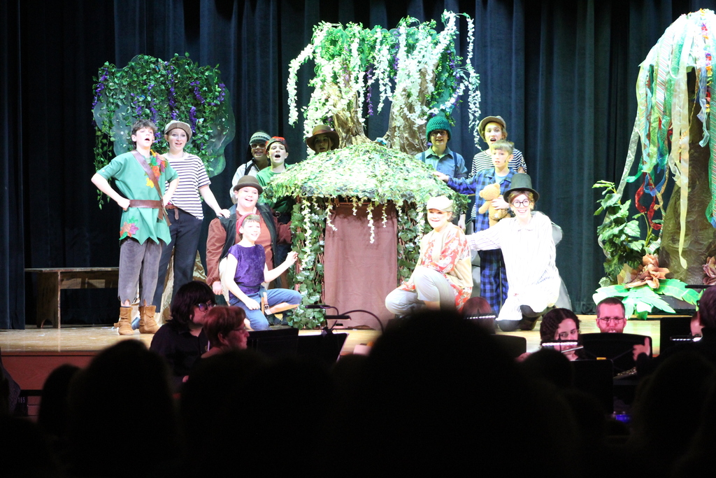 students in costume on stage