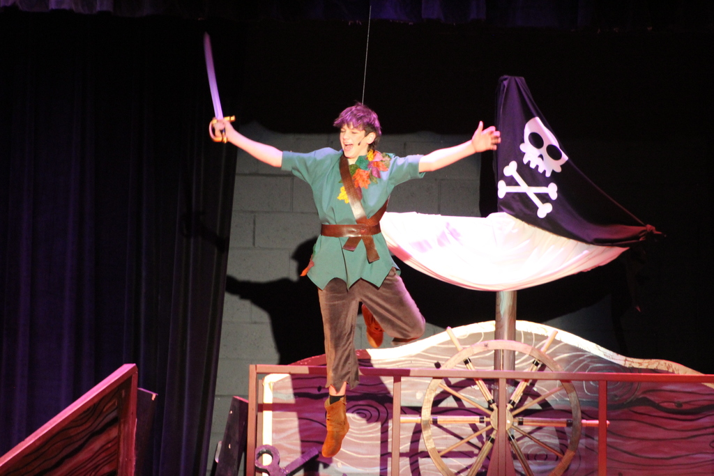 student flying on stage