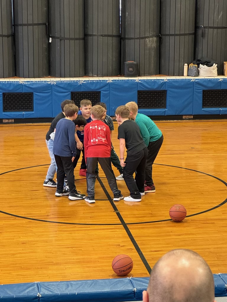 students in a circle in the gym
