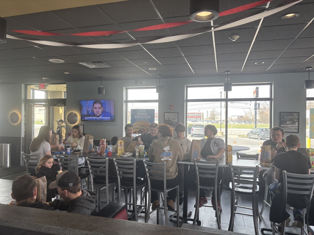 students sitting at a table in a restaurant