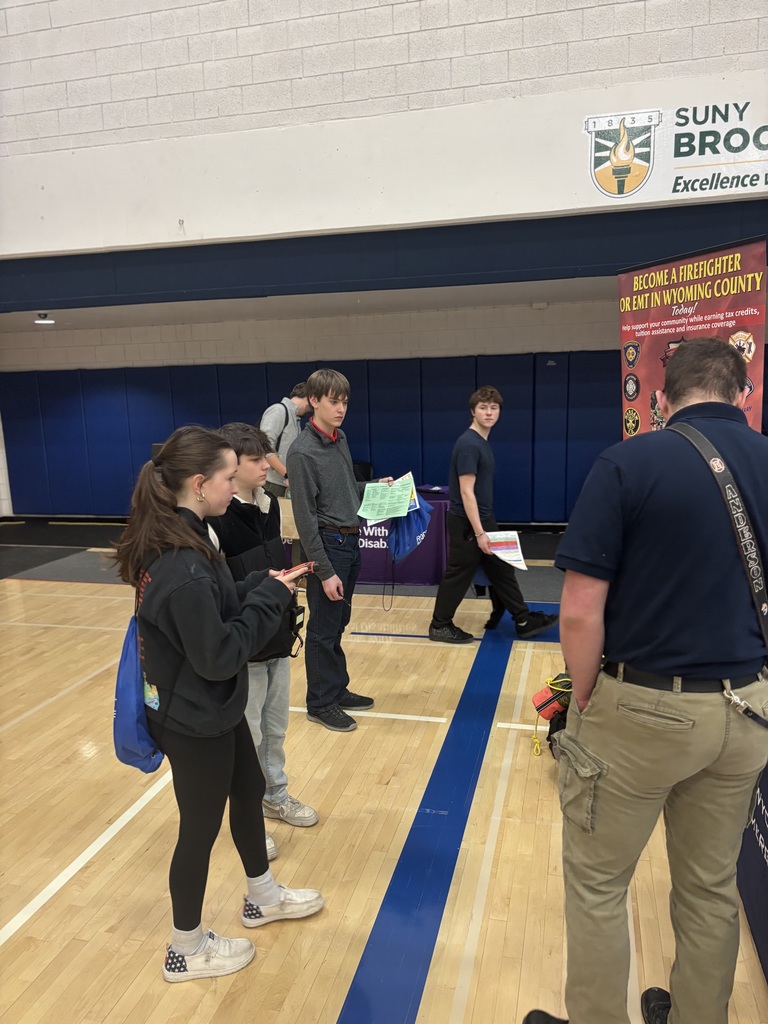 students watching a booth presentation