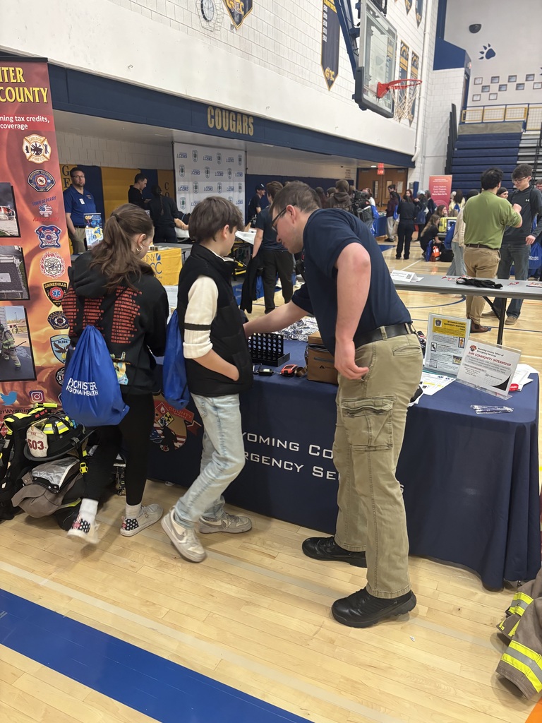 students watching a booth presentation