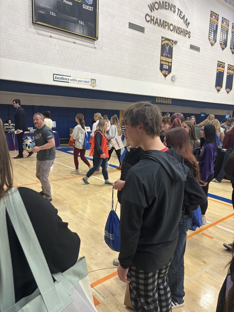 students watching a booth presentation